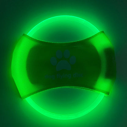 A dog catching a red glowing LED frisbee with other color options shown in separate images. The frisbee is rechargeable and appears to be made of a soft, durable material.