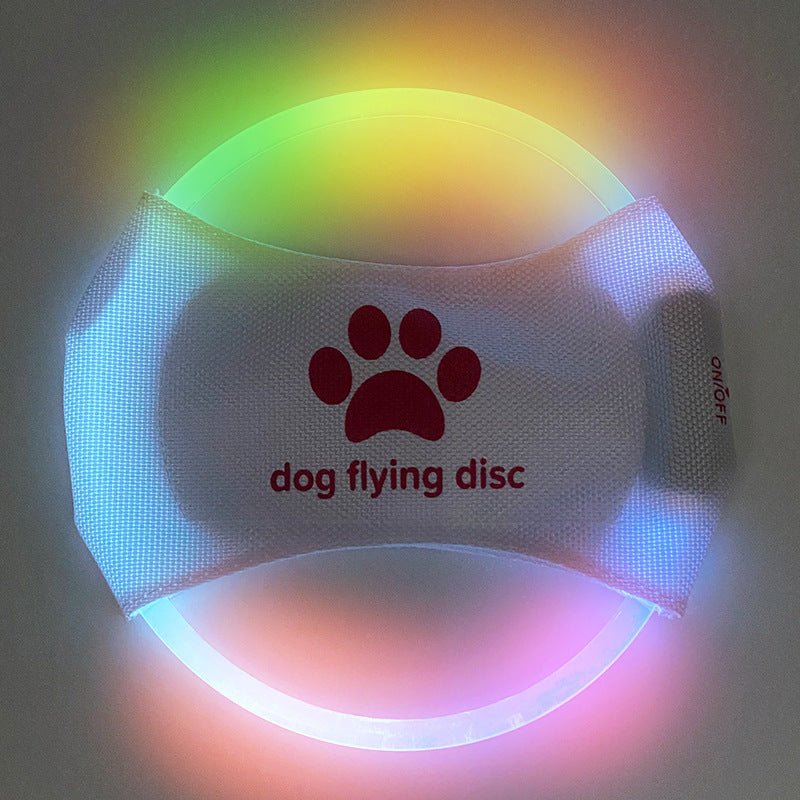 A dog catching a red glowing LED frisbee with other color options shown in separate images. The frisbee is rechargeable and appears to be made of a soft, durable material.