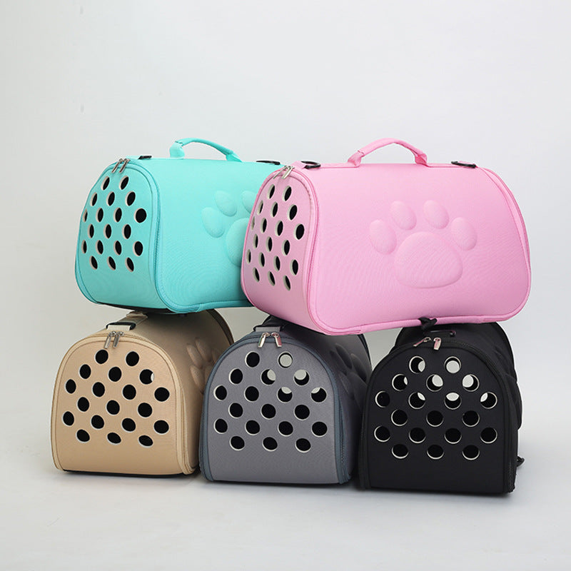 A collection of Footprint folding pet carriers in various colors including green, black, brown, gray, and pink, designed for small pets like cats and dogs.